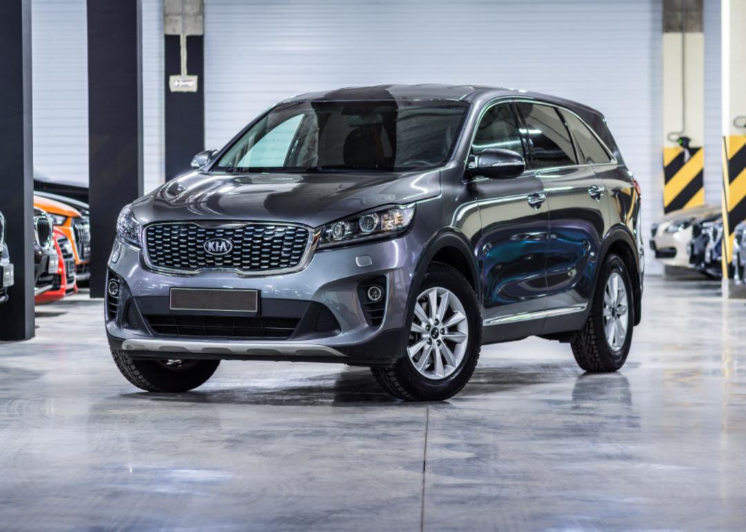 A gray Kia Sorento in a warehouse.