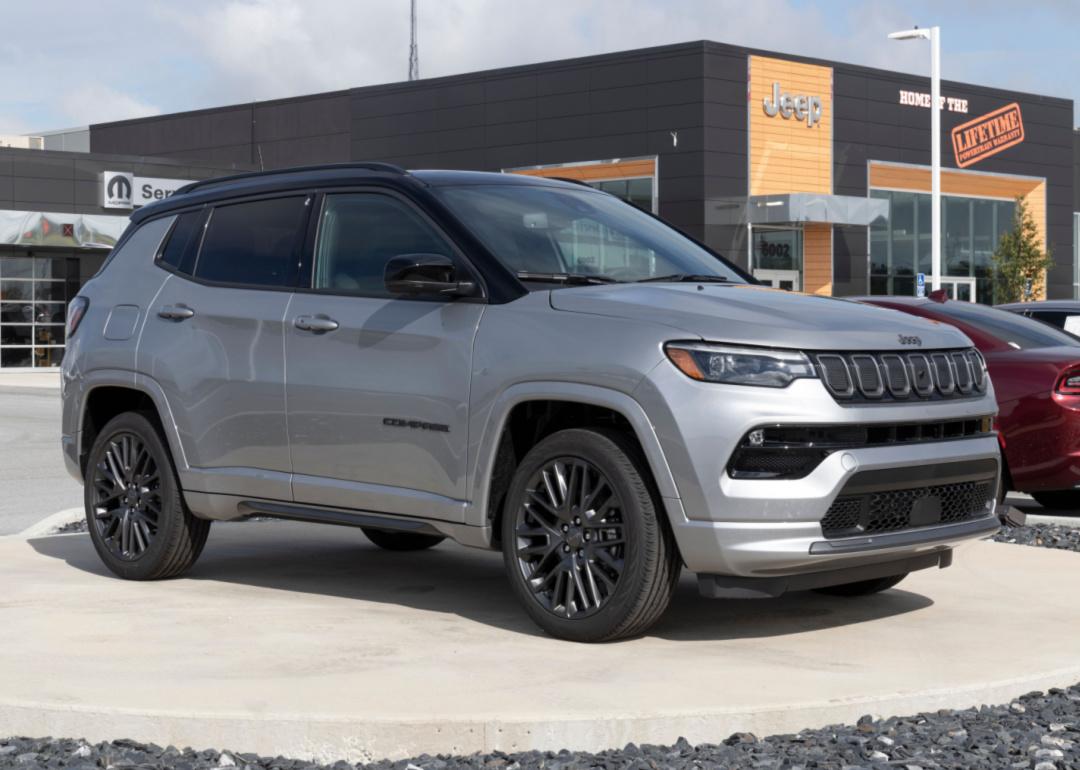 A gray Jeep Compass at a dealership.