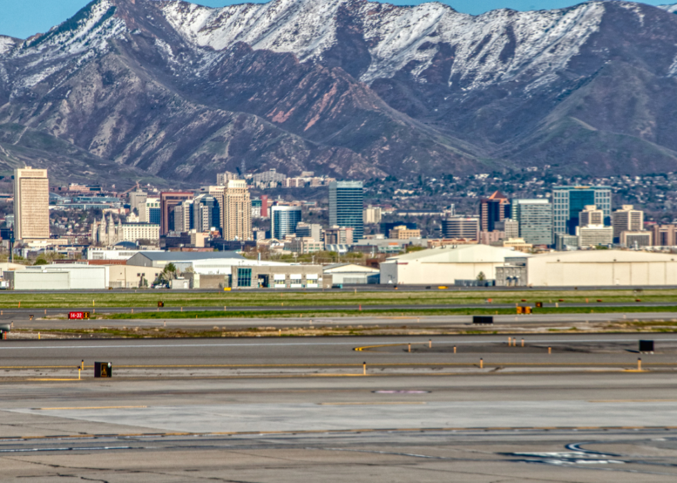Salt Lake City airport with a view of downtown on the horizon and snowy mountain peaks in the background.