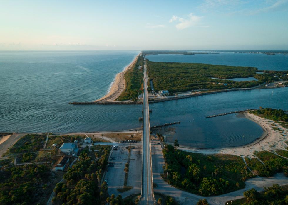 Aerial view of the masses of land surrounded by water and connected by bridge.