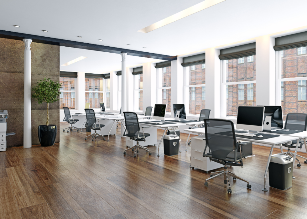 A modern office with large windows.