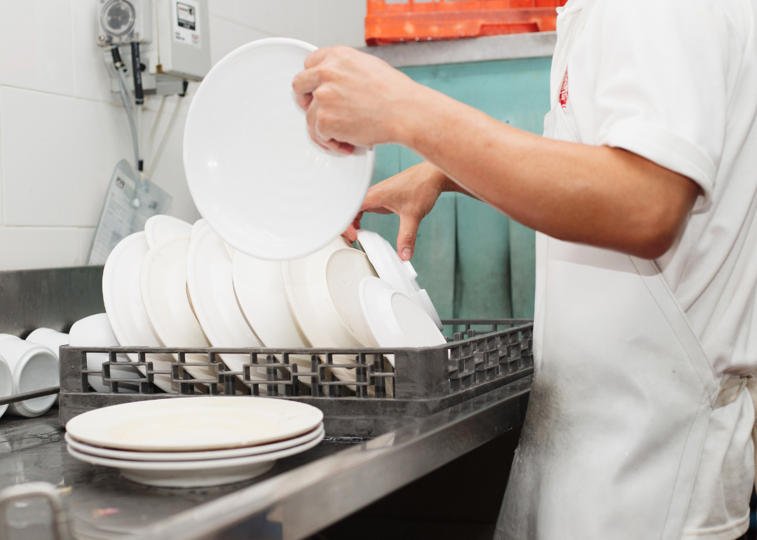 A dishwasher arranging dishes to dry