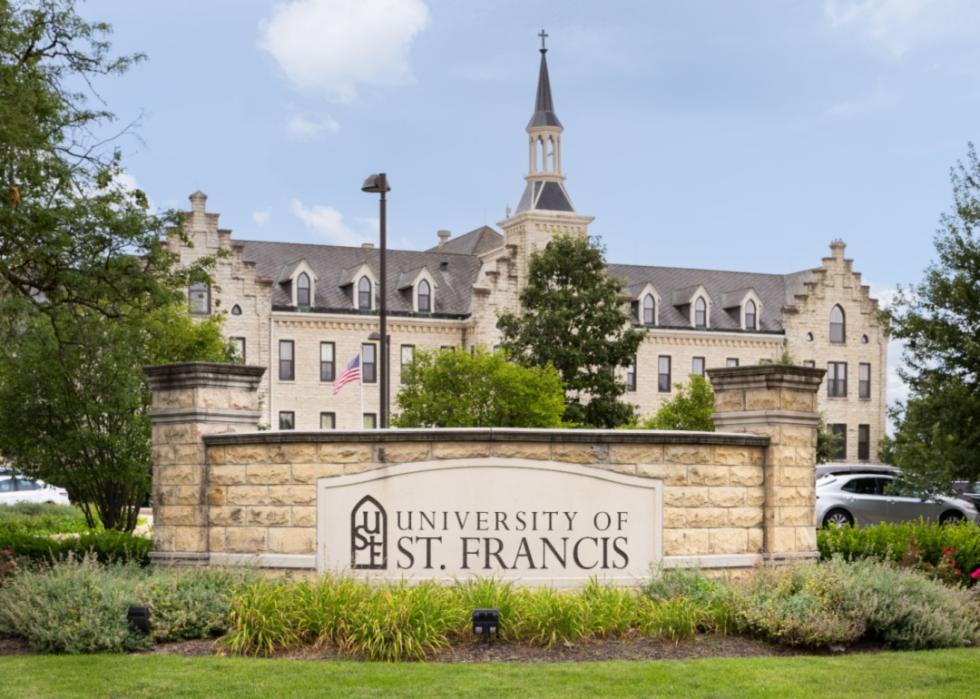 A white stone building and sign at the University of St. Francis.