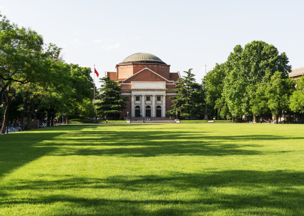 An old brick building with a green lawn at Tsinghua University.