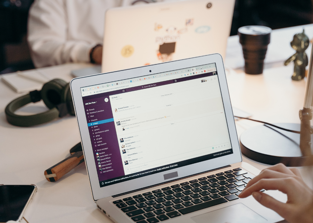 A businessperson's laptop open to Slack.