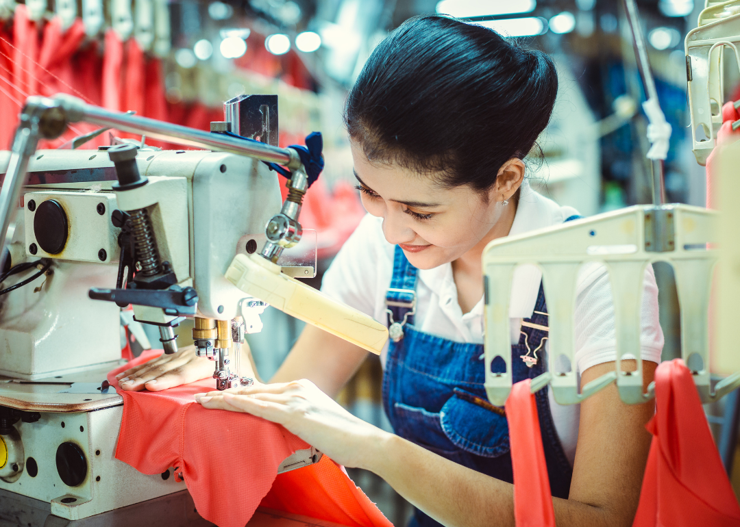 A seamstress working in a textile factory.