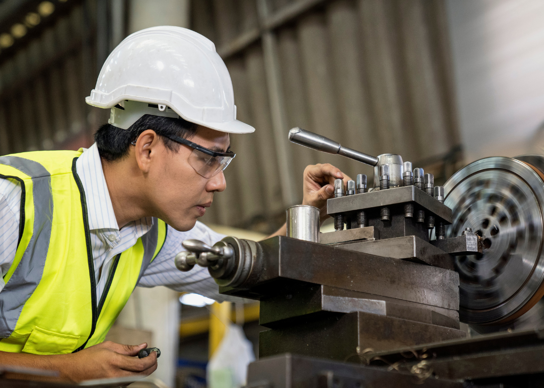 An engineer operating a machine in an industrial factory.