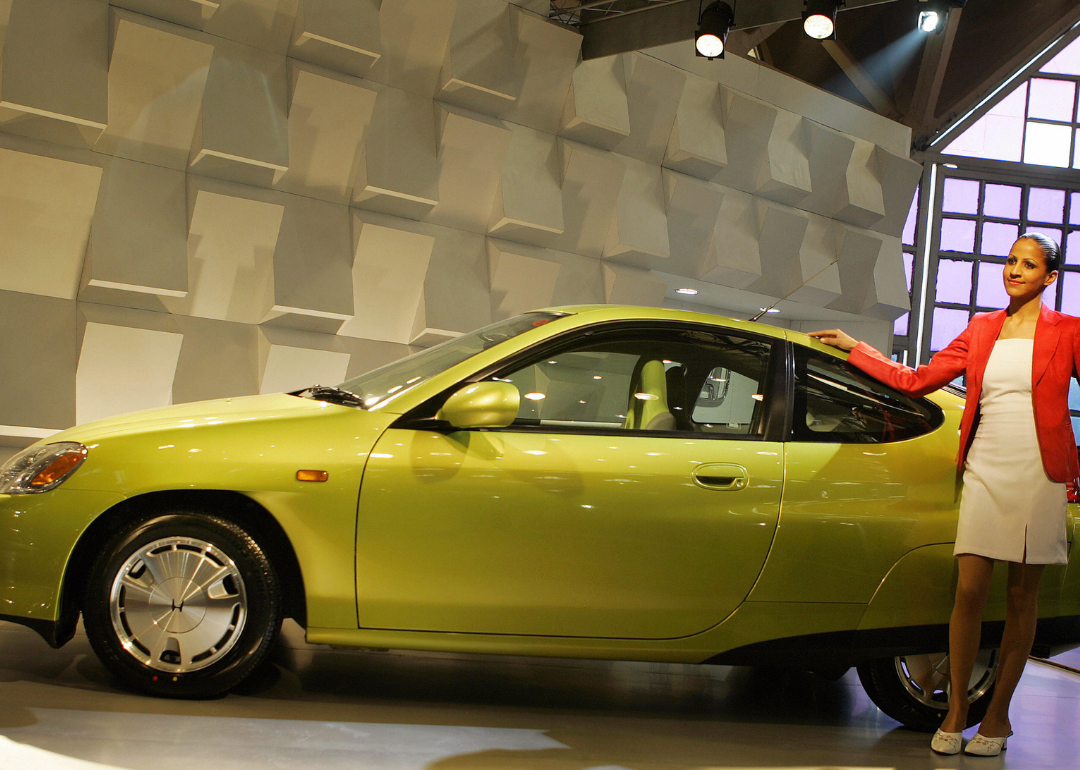 A model posing with a Honda Insight.