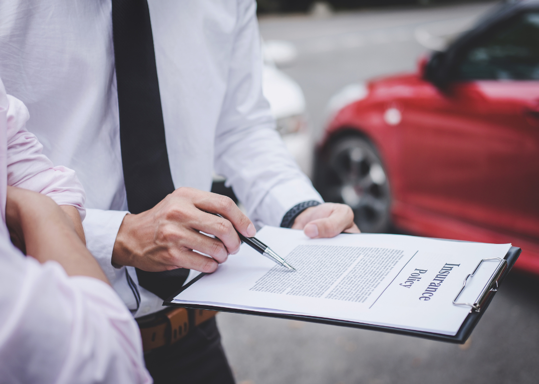 A car insurance agent explaining a policy to a client.