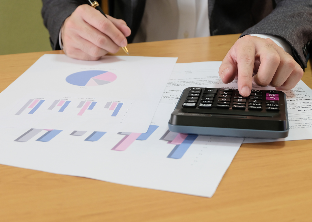 A printed budget with a pie chart showing the percentage's a person's income that will go to different expenses.