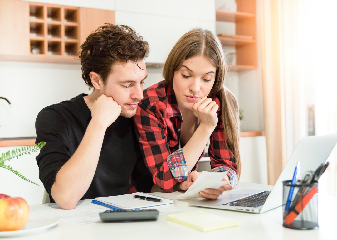 A couple revising their household's budget.