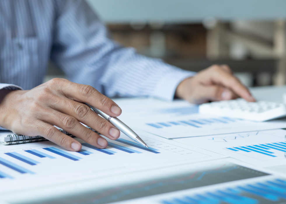 A financial manager looking a printed graphs