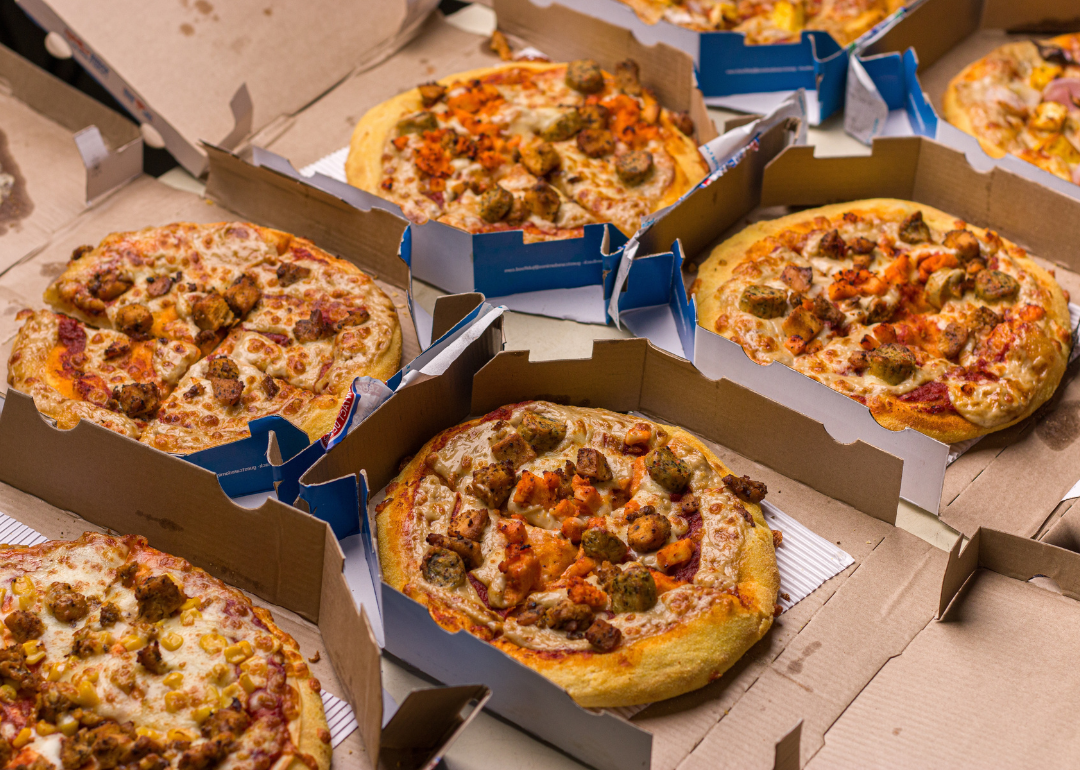 Several open Domino's pizza boxes.