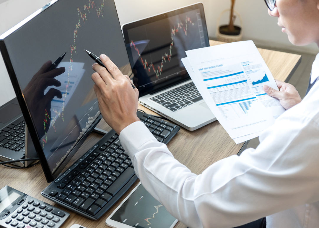 A person looking at financial graphs