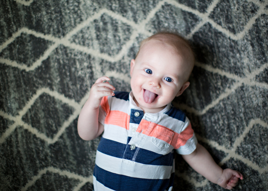 A baby sticking their tongue out.