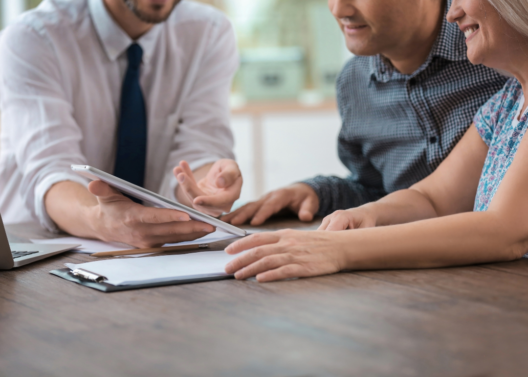 An insurance underwriter meets with potential clients
