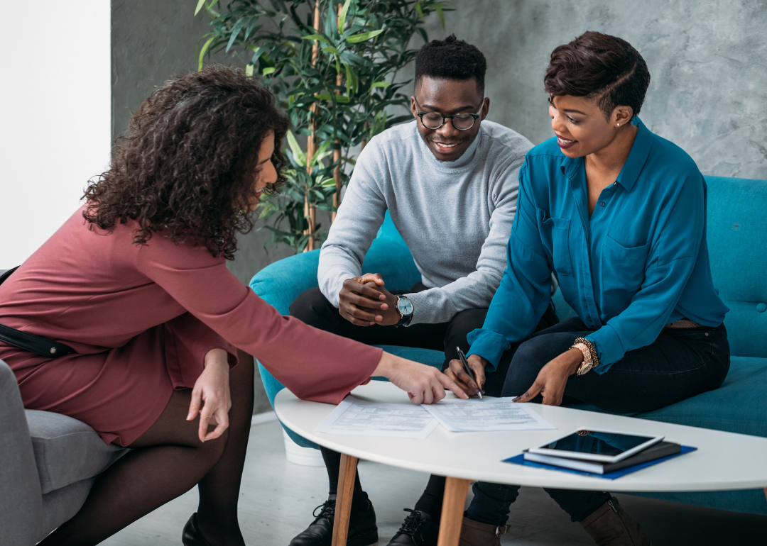 A couple speaking with a personal finance advisor.