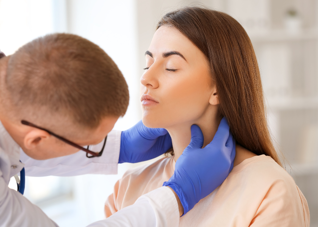 An endocrinologist inspecting a patient's throat.