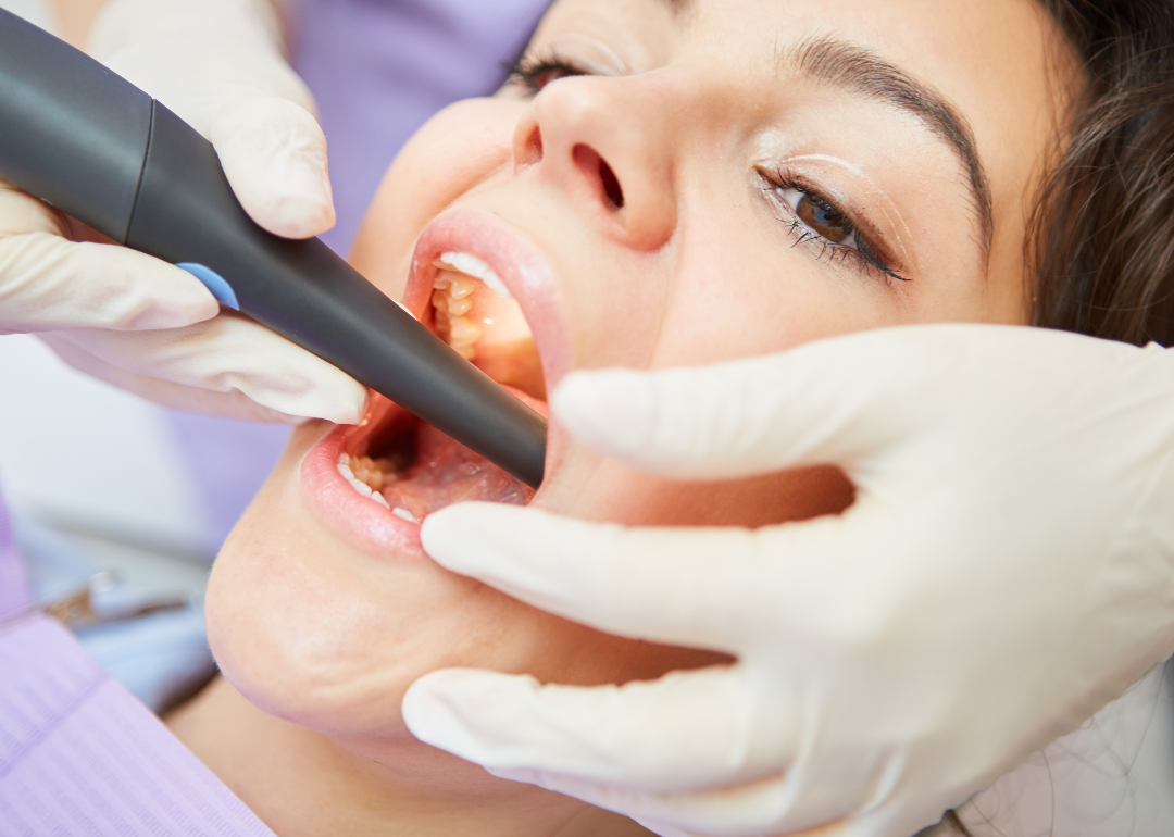 A doctor working inside a patient's mouth.