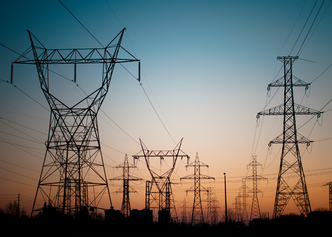 A long line of electrical transmission towers carrying high voltage lines.