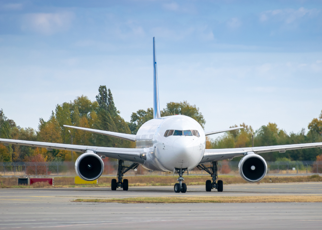 The front of a passenger plane on the tarmac