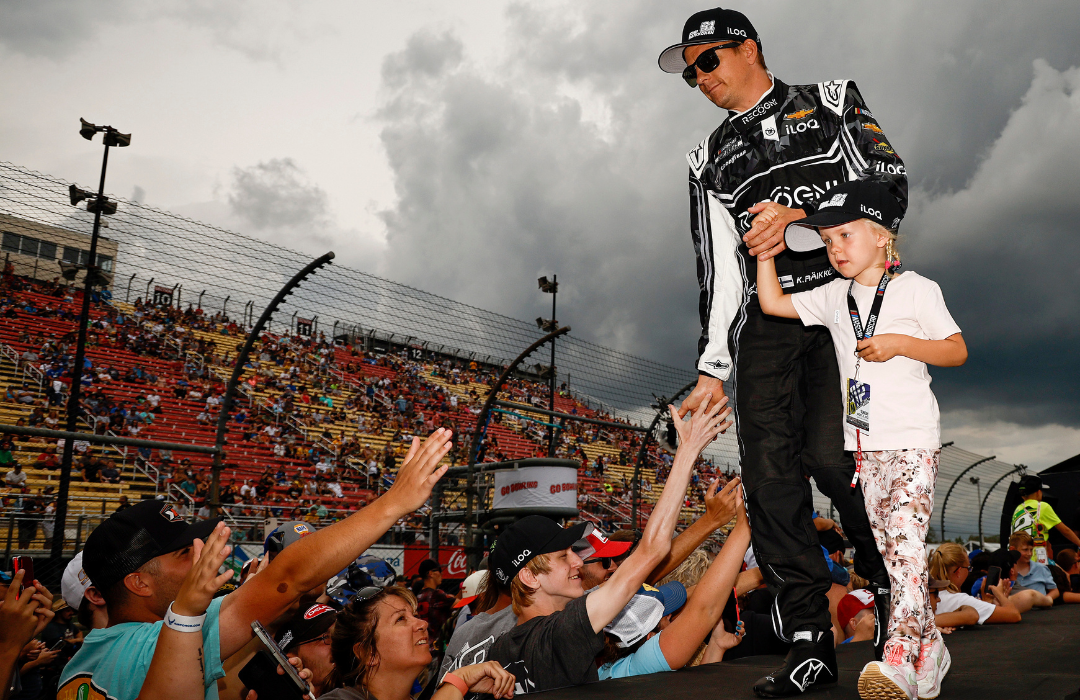 Kimi Raikkonen, driver of the #91 Recogni Chevrolet, and his daughter greeting fans during driver intros prior to the NASCAR Cup Series Go Bowling at The Glen at Watkins Glen International on August 21, 2022.