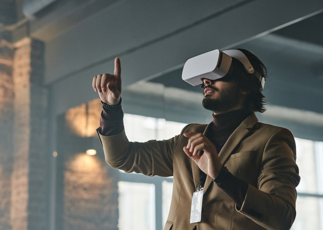 A person wearing VR goggles in an office.
