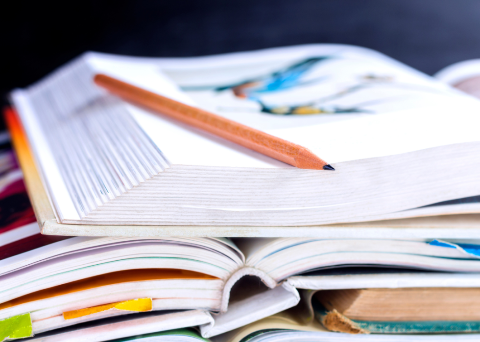 A stack of open textbooks.