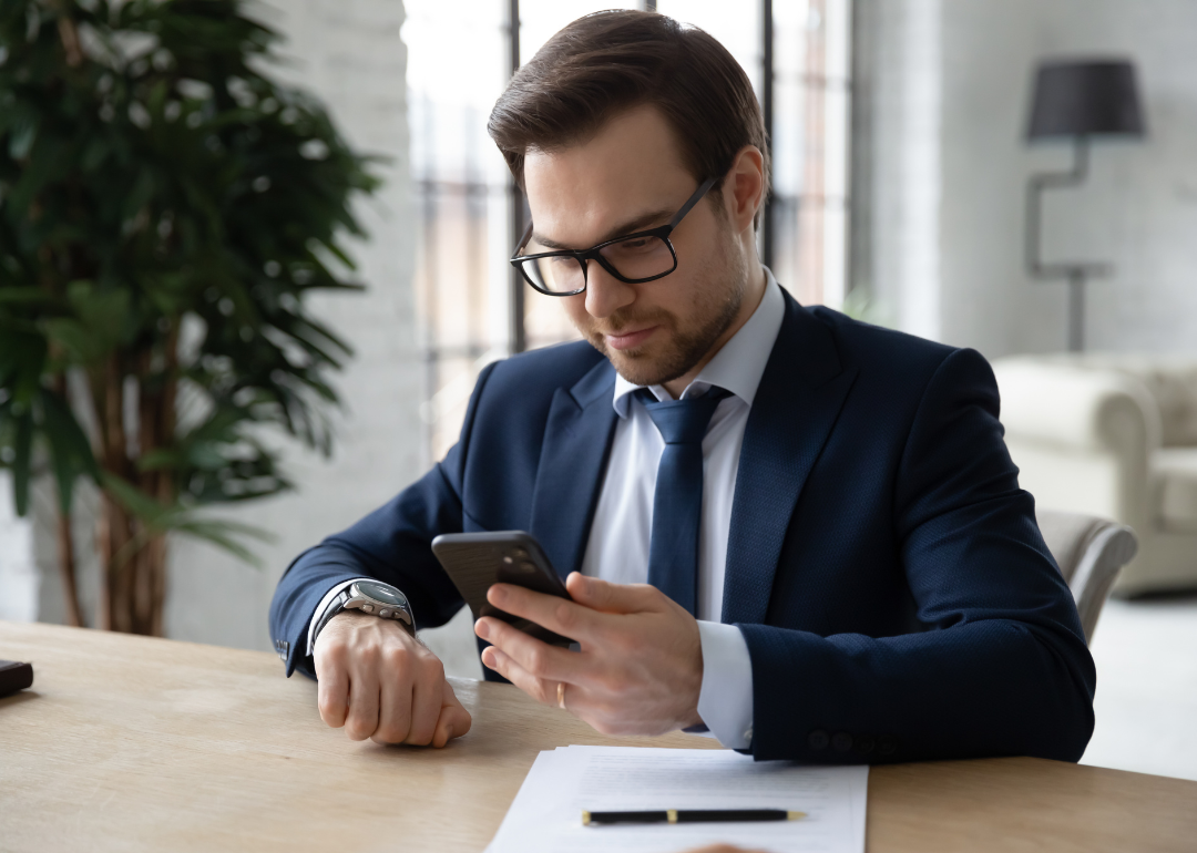 An employee using a mobile app on their phone to clock in for work