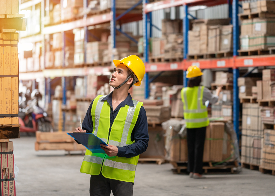 Two workers taking inventory in a warehouse.