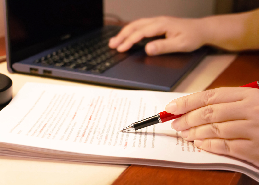 A proofreader works on documents.