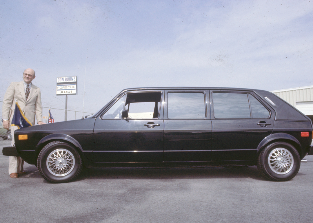A man standing next to a 77 VW Rabbit.