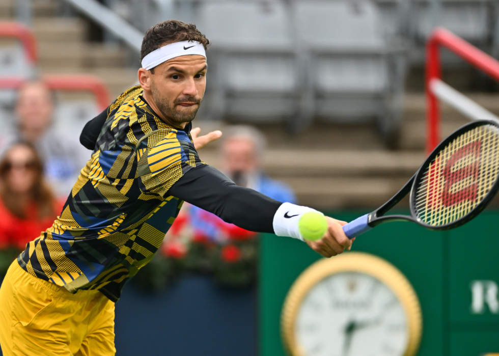 Grigor Dimitrov of Bulgaria hitting a return against Alexis Galarneau of Canada during day 4 of the National Bank Open at Stade IGA on August 9, 2022 in Montreal, Canada
