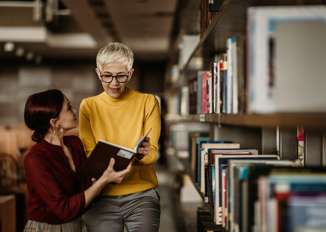 A librarian helps a customer.