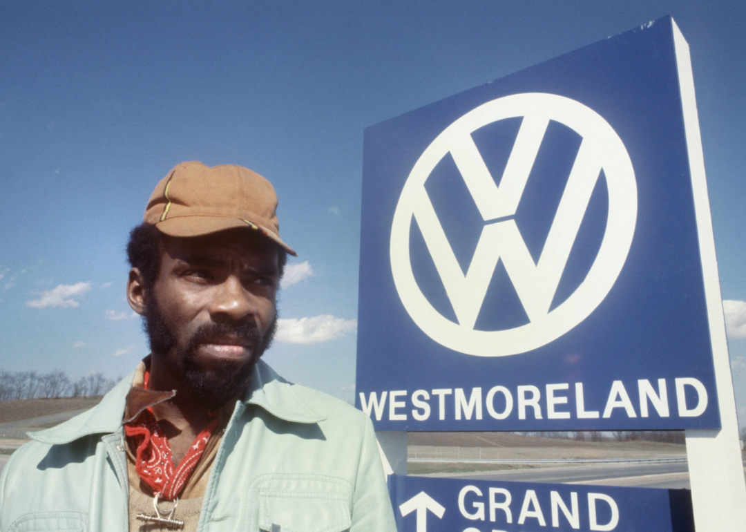 A worker outside a manufacturing plant for VW Rabbits.