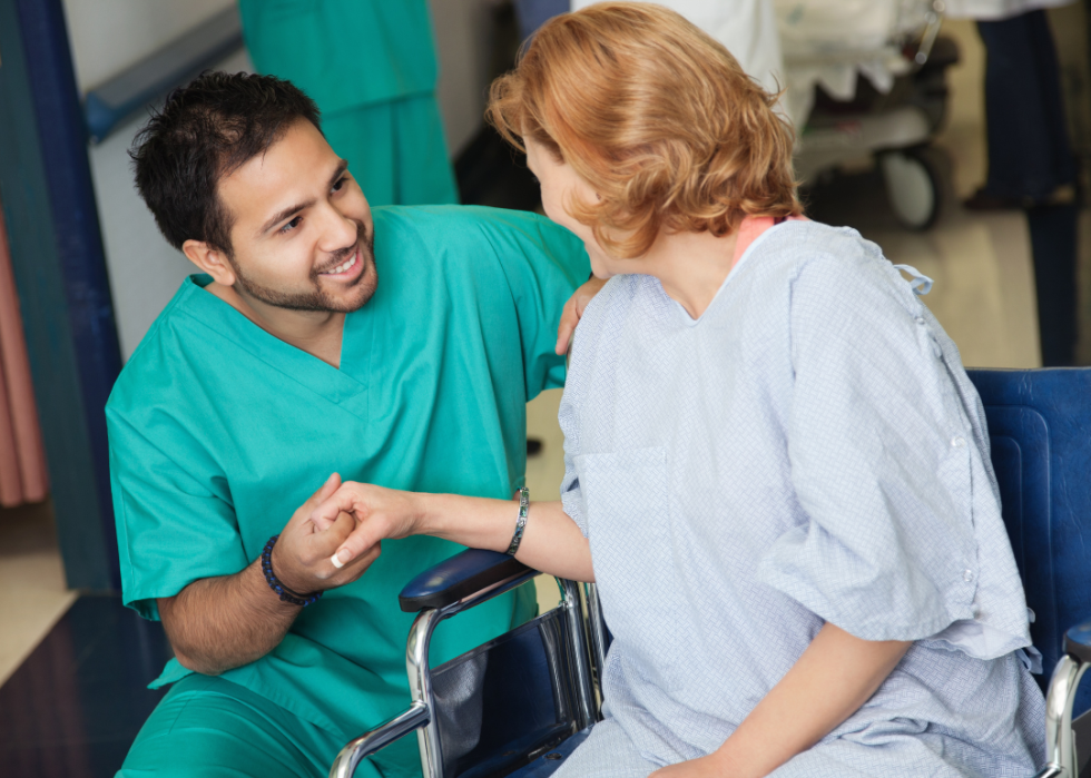 A nurse assisting a patient in a wheelchair