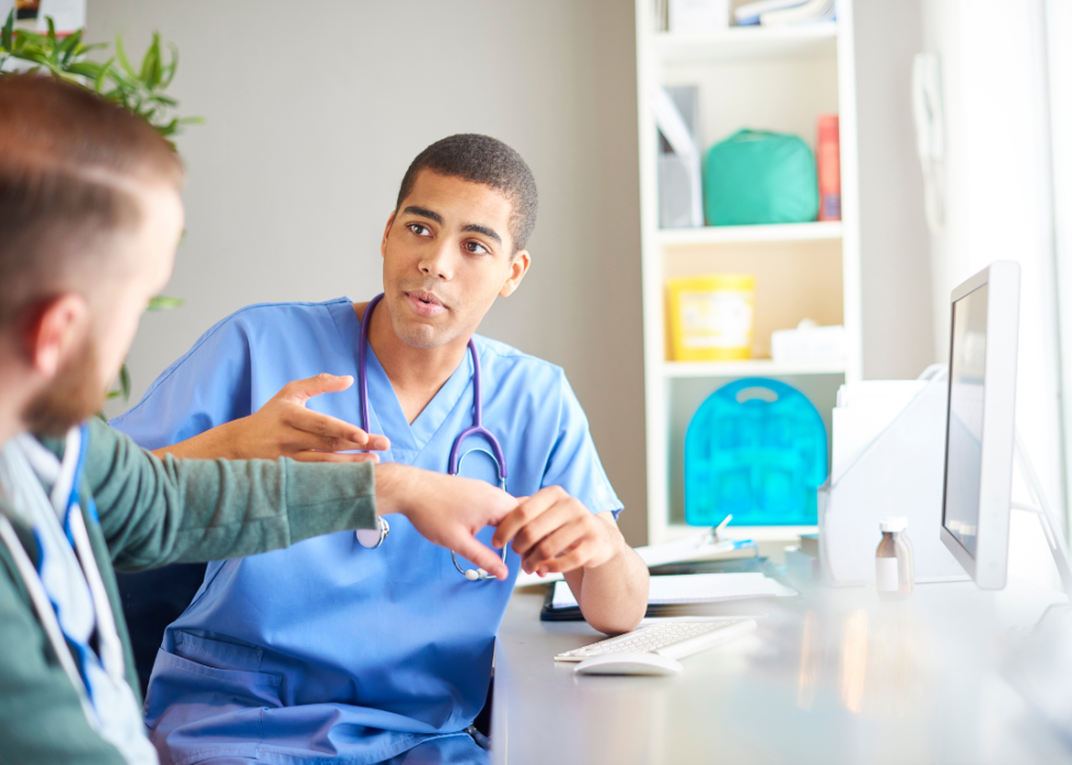 A nurse listening to his patient