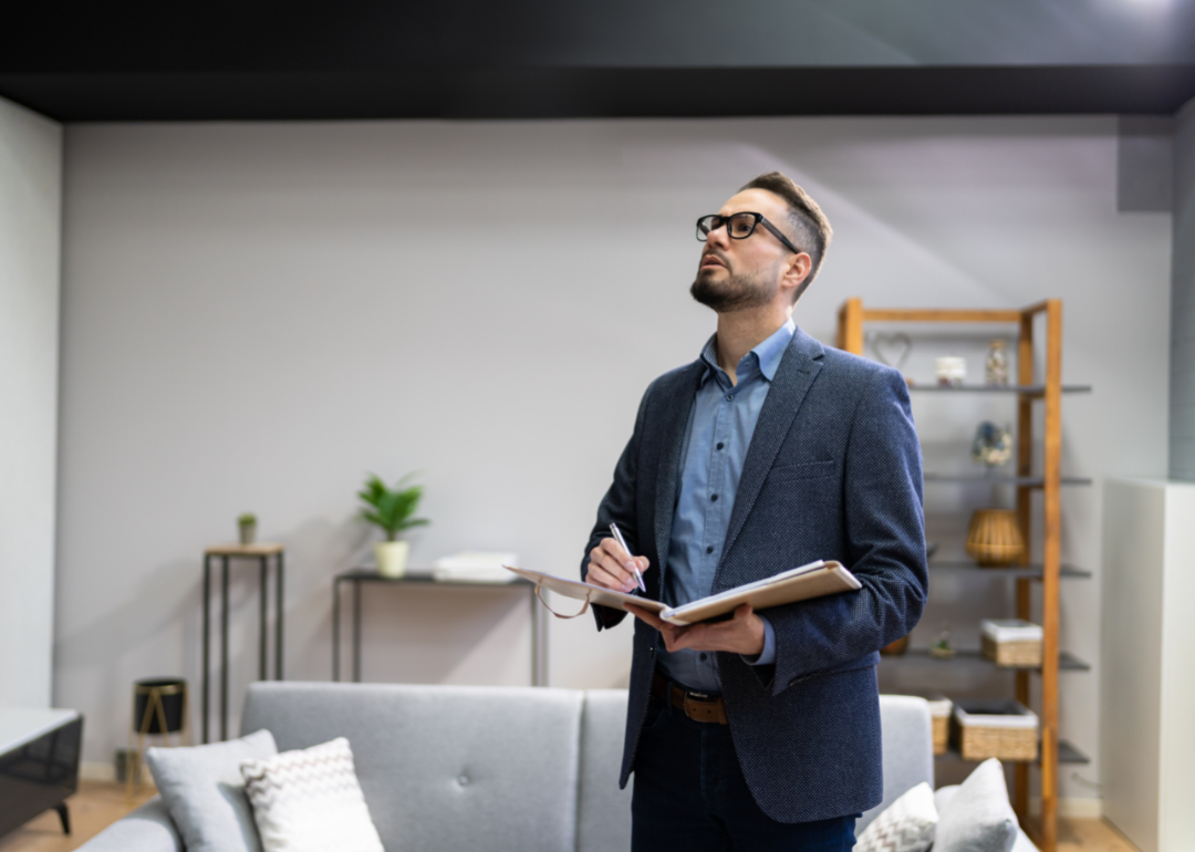 A property appraiser taking notes while assessing a property