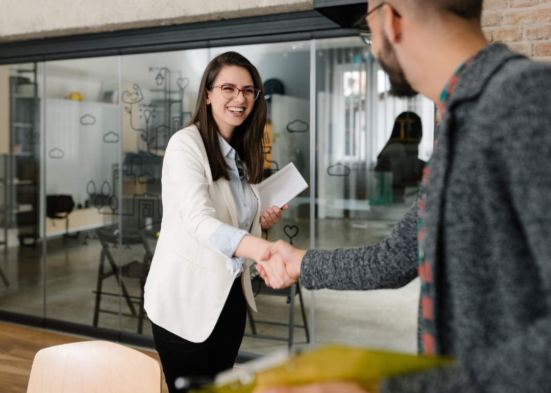 A human resources specialist greeting a new potential employee for an interview