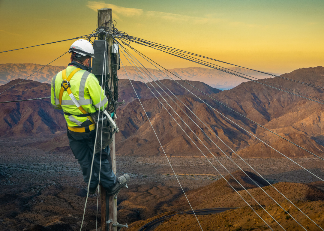An engineer repairing a desert telephone line.
