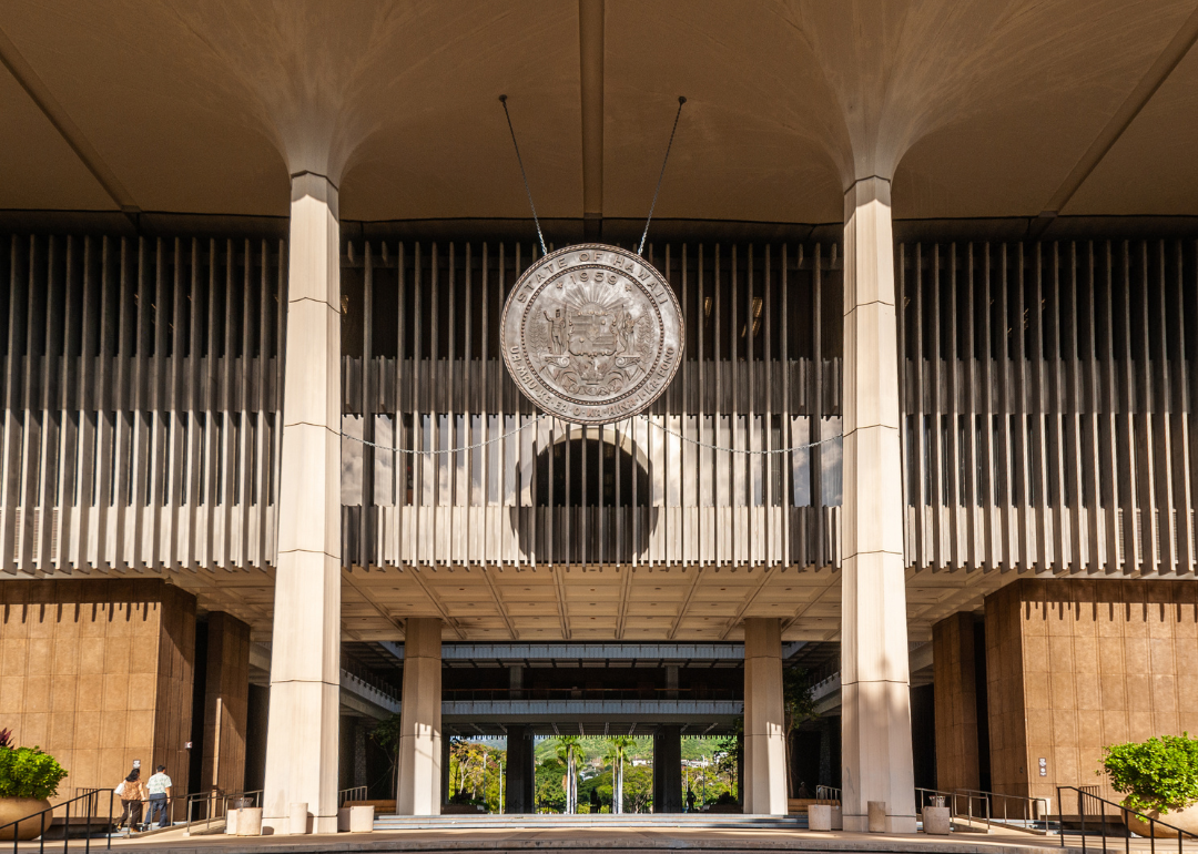 The Bronze Seal of State of Hawaii hanging from ceiling above entrance to State Capitol in Honolulu.
