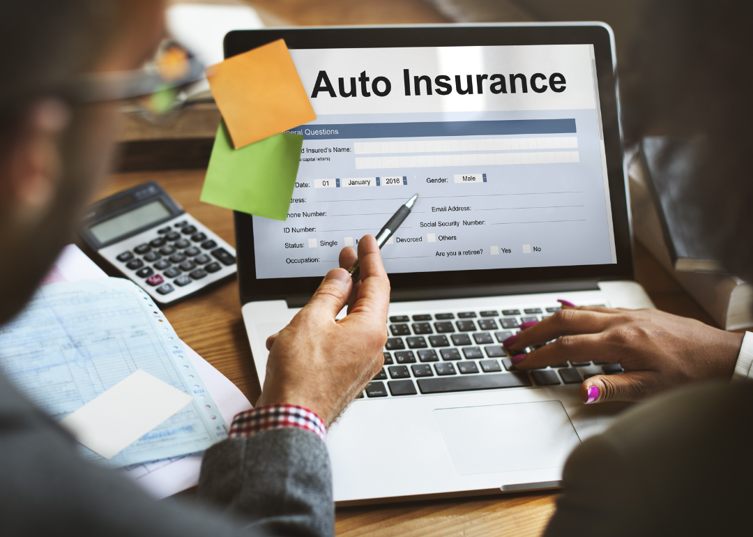 Two people looking at their personal auto insurance on a laptop.