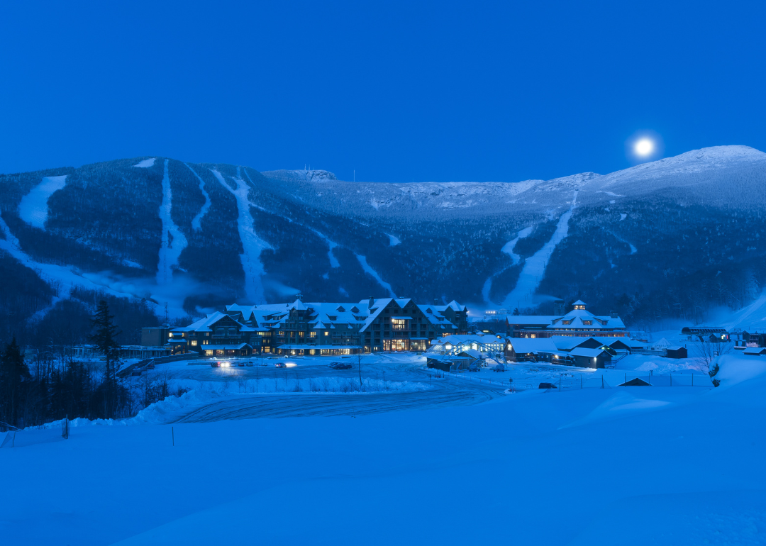 The moon setting over a snow-covered Mt. Mansfield in Stowe.