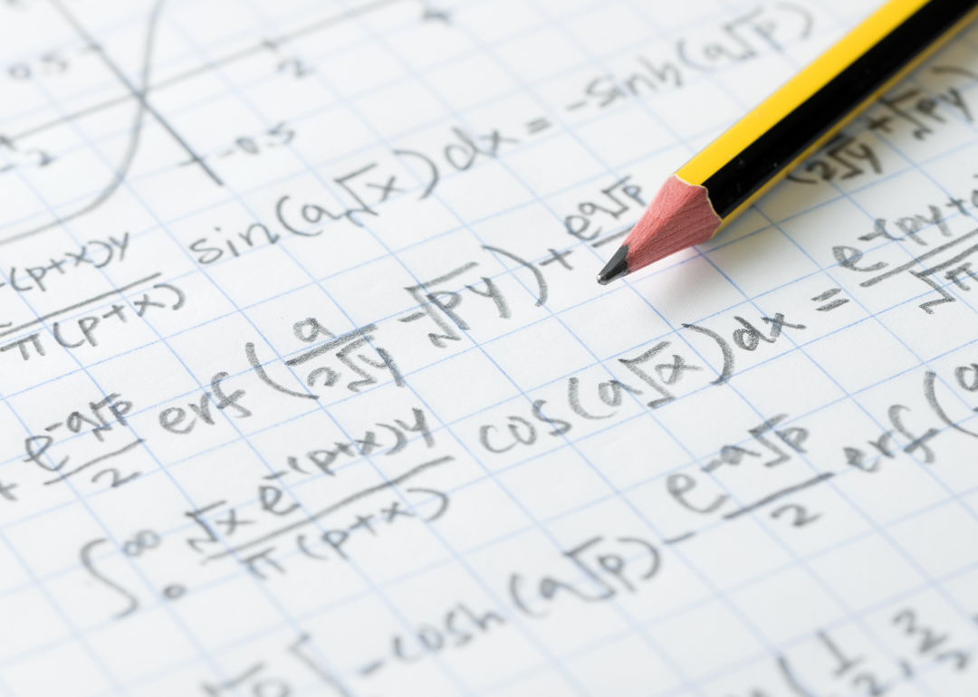 Parts of a math problem appear on a piece of paper.