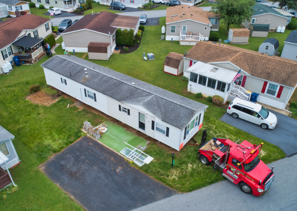 A manufactured, mobile, prefab home being removed from a lot in a park