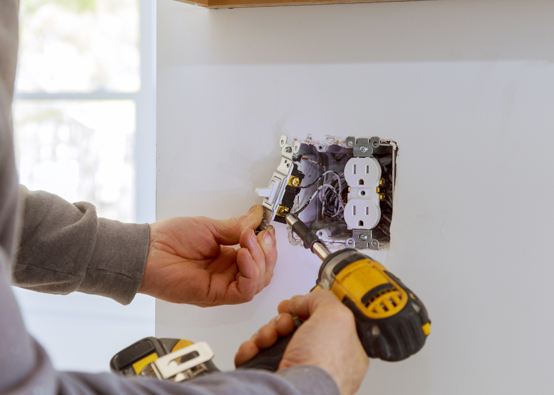 A person installing electrical outlets