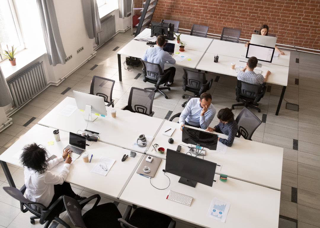 Employees working together in an open office space.