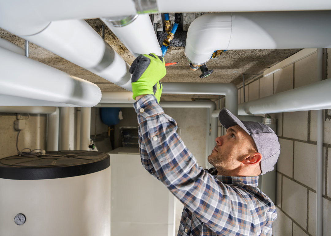 A plumbing contractor finishing the installation of a sanitary pipeline.