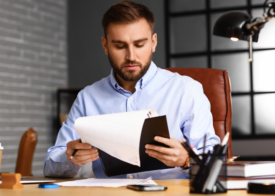 An insurance underwriter reviews a file to determine into which group a new client should be placed.