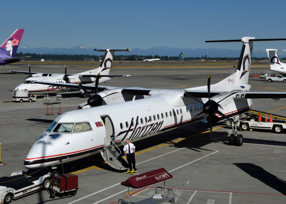 A pilot at the airstairs of a Horizon Air Bombardier DHC-8 Dash 8-400 Q400